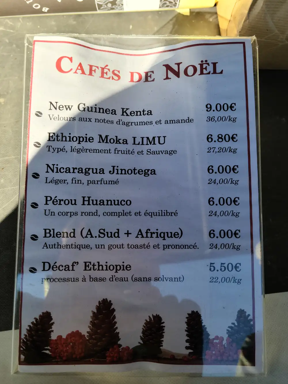 Cafés de Noël Christmas coffee menu listing single-origin beans and prices at a Bordeaux roaster shop