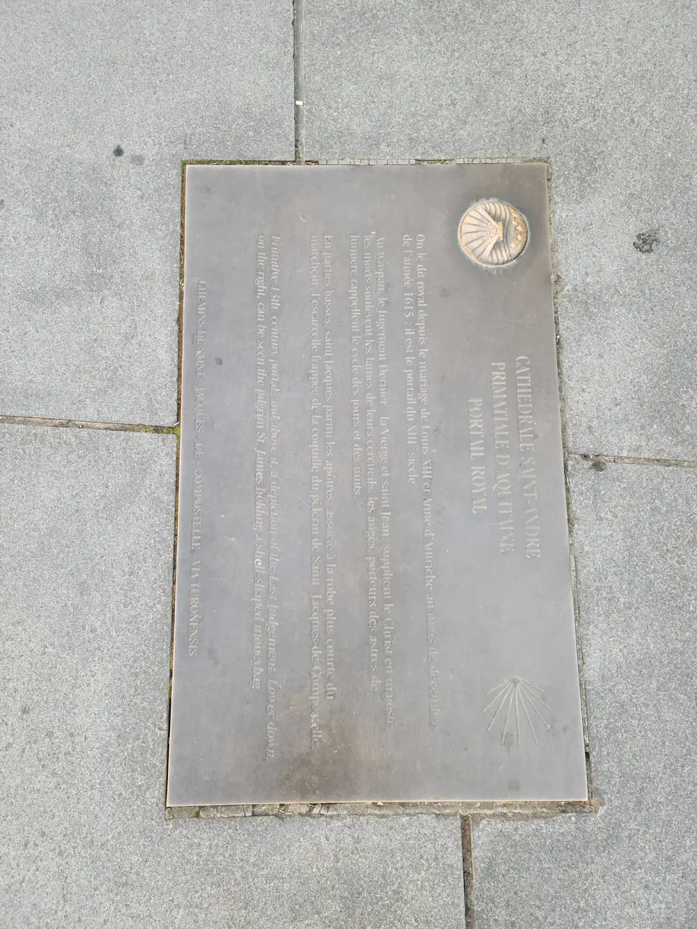 Bronze pavement plaque describing the Portail Royal of Cathédrale Saint-André set into stone paving in Bordeaux