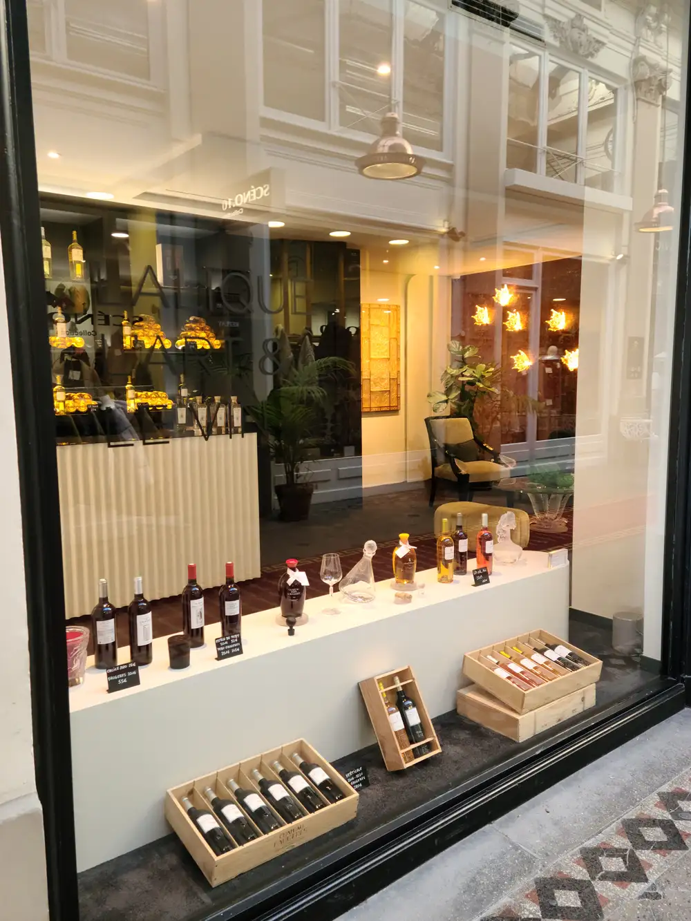 Lalique Scent & Art boutique window display with wine bottles, crystal decanters, and crafted decor in central Bordeaux