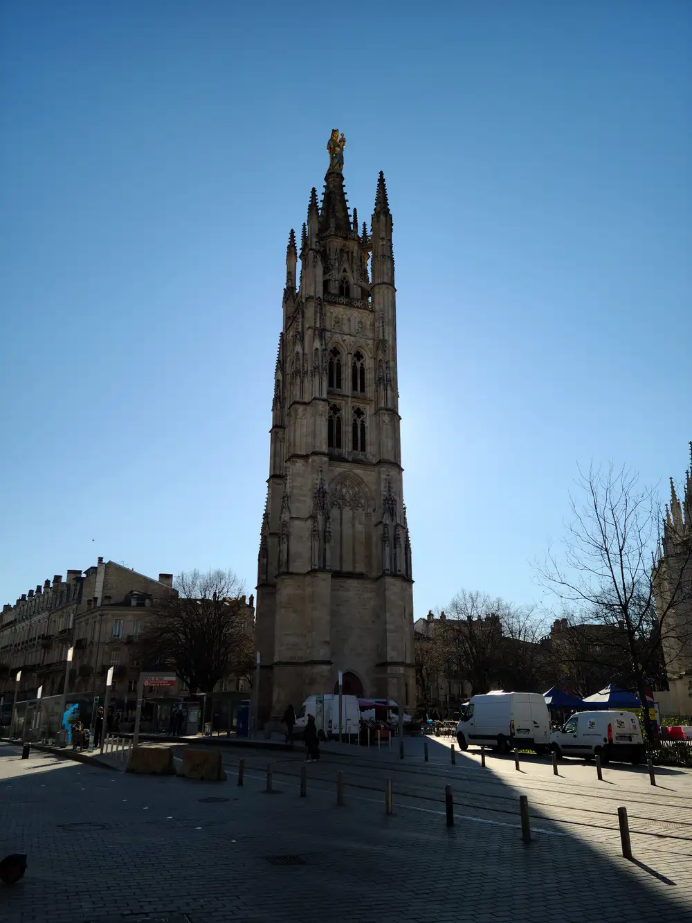 Tour Pey-Berland Gothic bell tower topped with gilded Virgin Mary statue rising above a sunlit square in Bordeaux