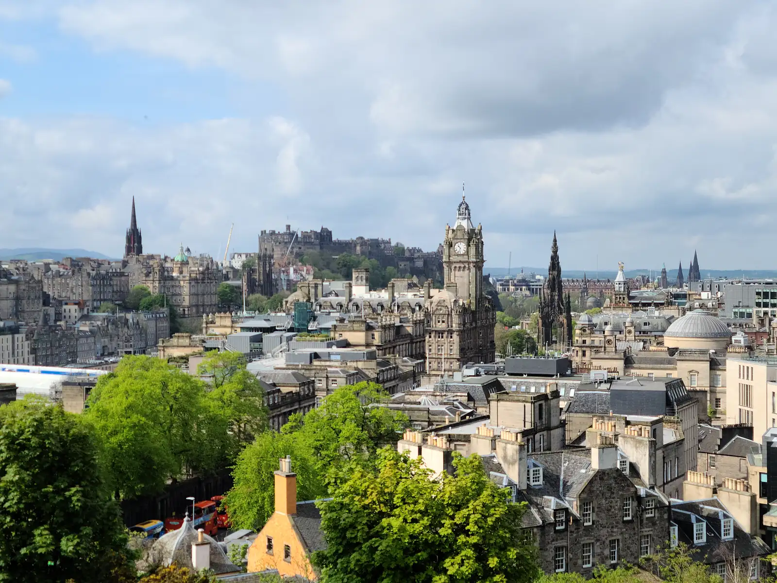 View from Calton Hill of Edinburgh Castle, Balmoral Hotel clock tower and Old Town spires under a cloudy sky