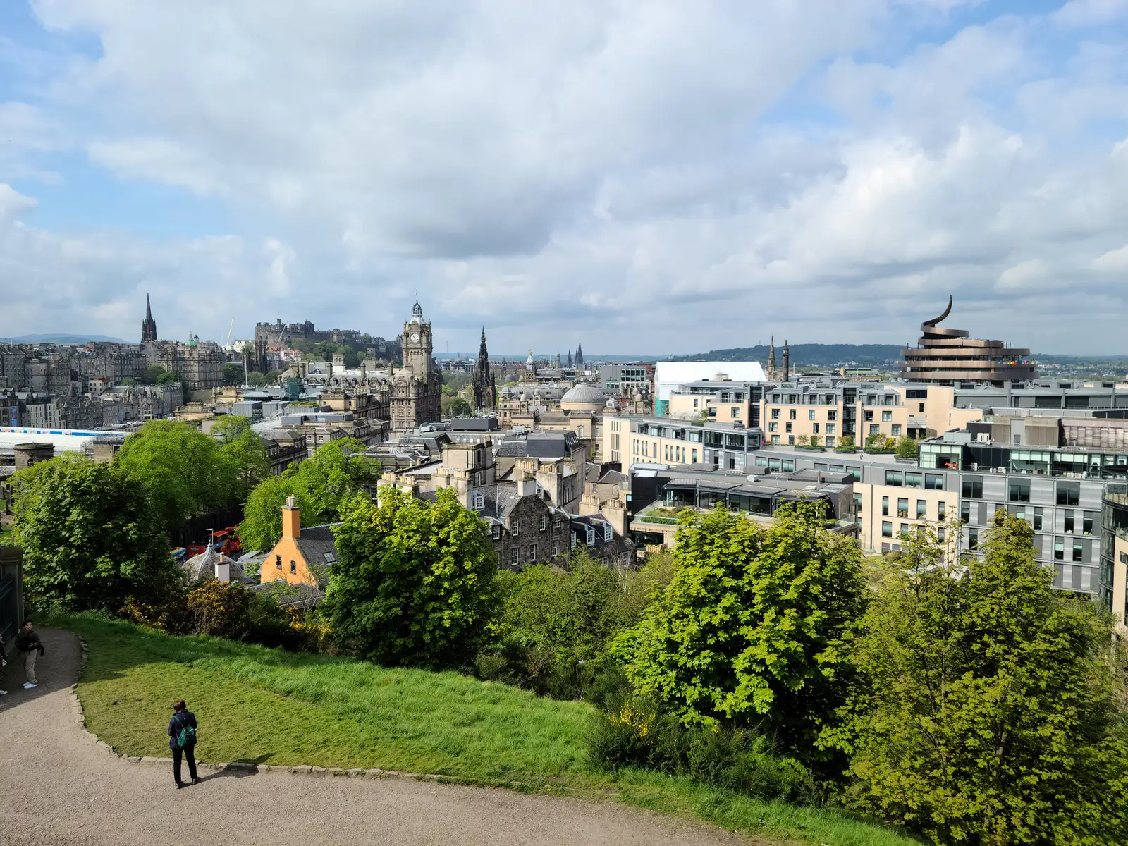 View from Calton Hill across Edinburgh rooftops with Balmoral clock tower, Castle and the curved Omni Centre horns