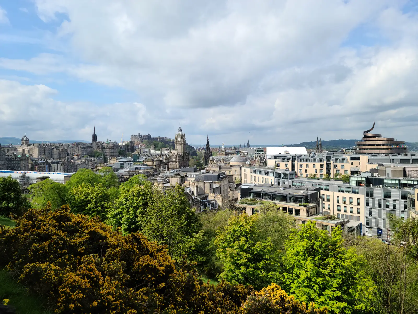 View from Calton Hill across Edinburgh with Castle, Balmoral clock tower, Scott Monument spire and St Andrew House dome