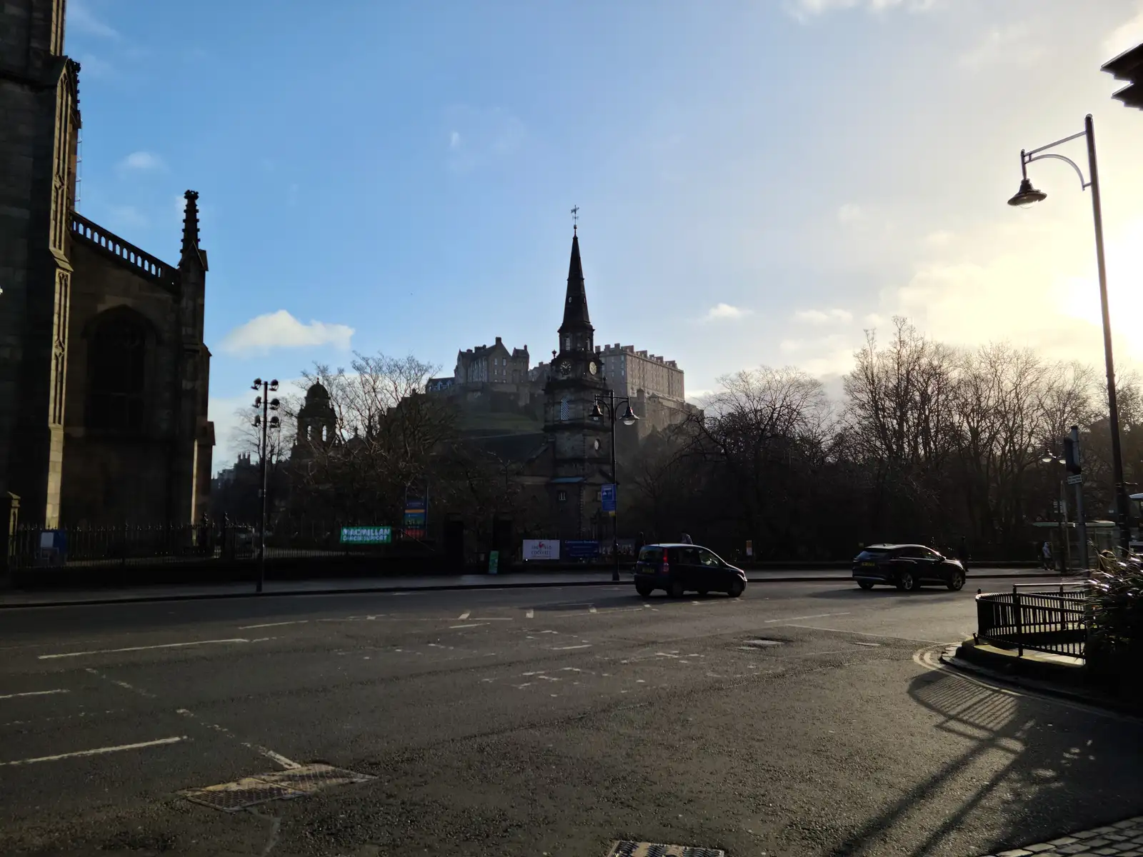 Edinburgh Castle on its rocky crag with the spire of St John's Episcopal Church in the foreground viewed from Lothian Road