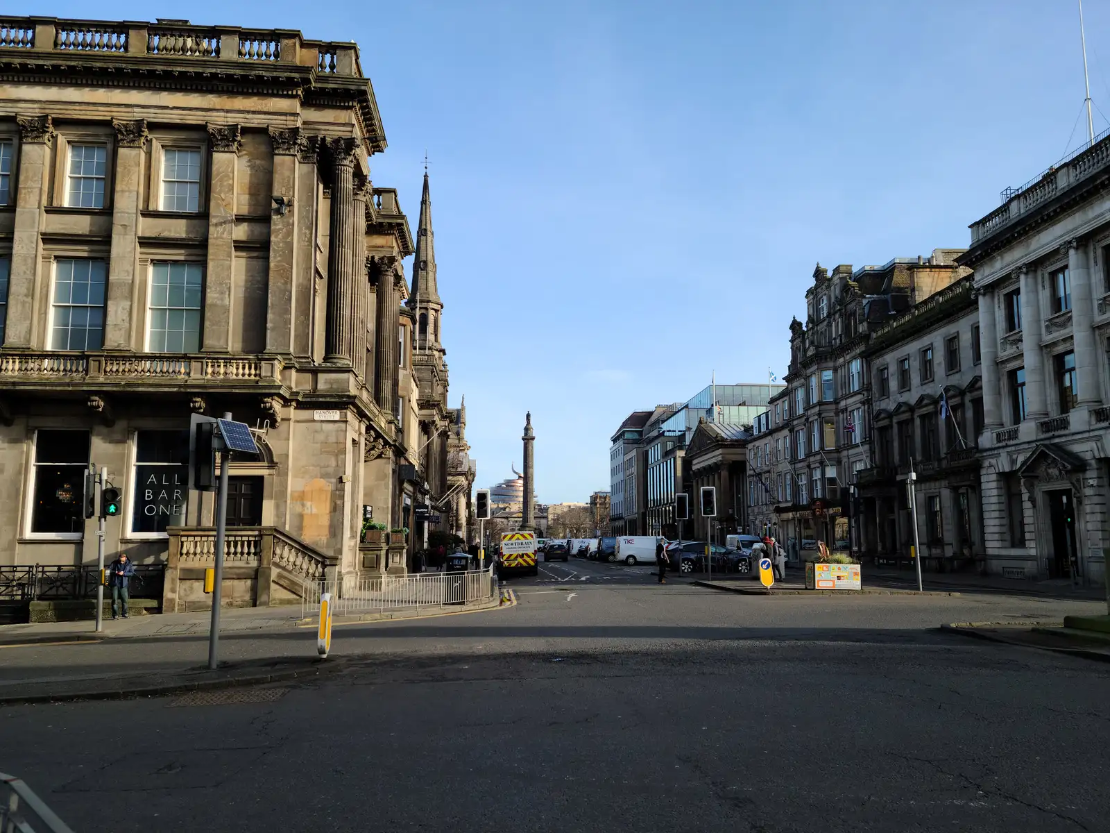 View along George Street in Edinburgh's New Town towards the Melville Monument with grand sandstone facades flanking the road