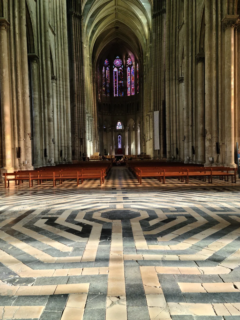 Interior nave of the Basilique de Saint-Quentin with soaring Gothic arches and stained glass windows