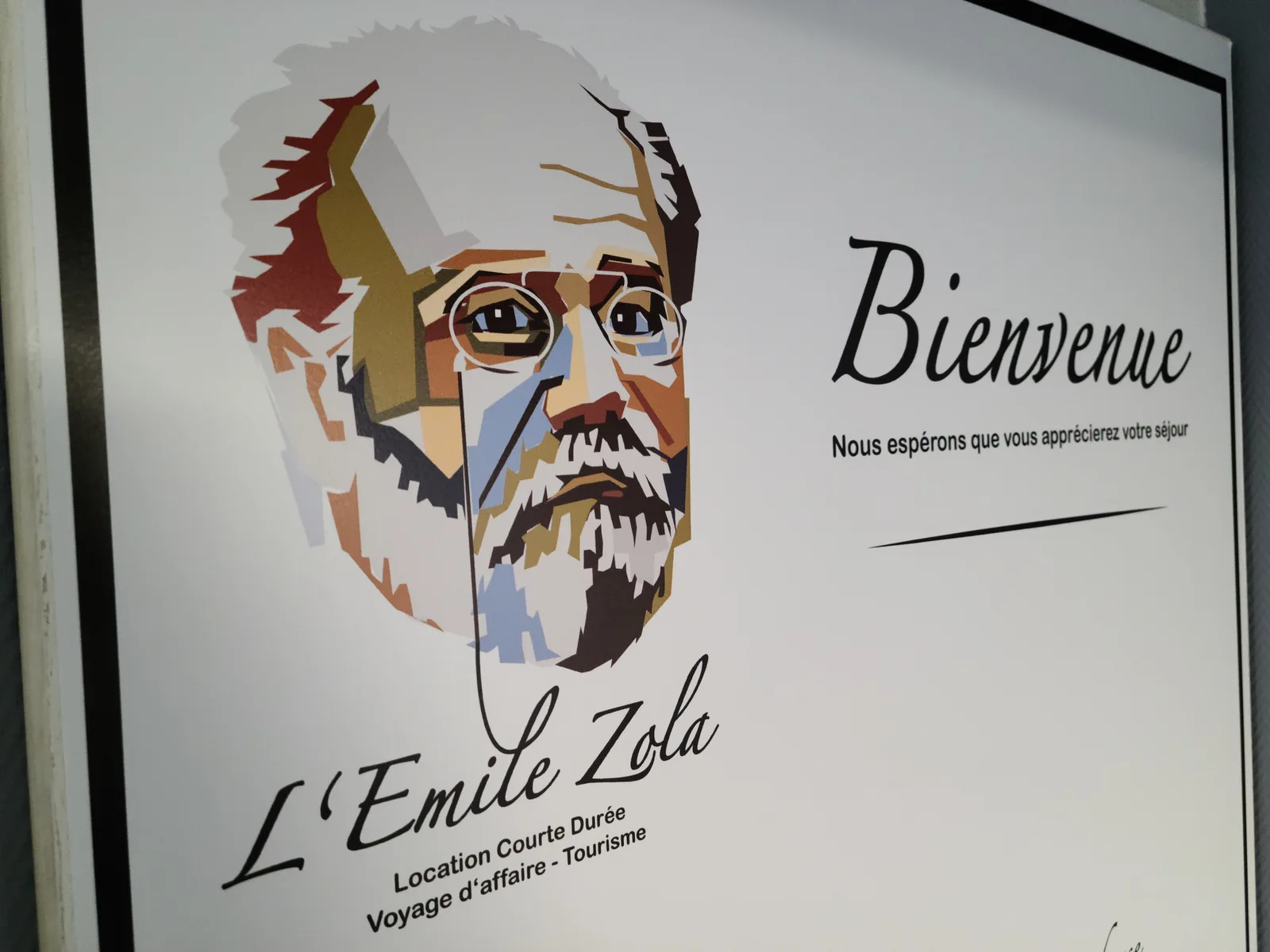Welcome sign for the Emile Zola gîte on a Saint-Quentin street