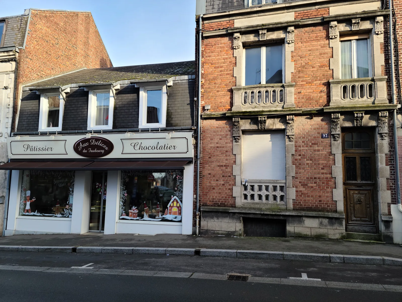 Art Nouveau patisserie and chocolatier shopfront with decorative stonework in Saint-Quentin