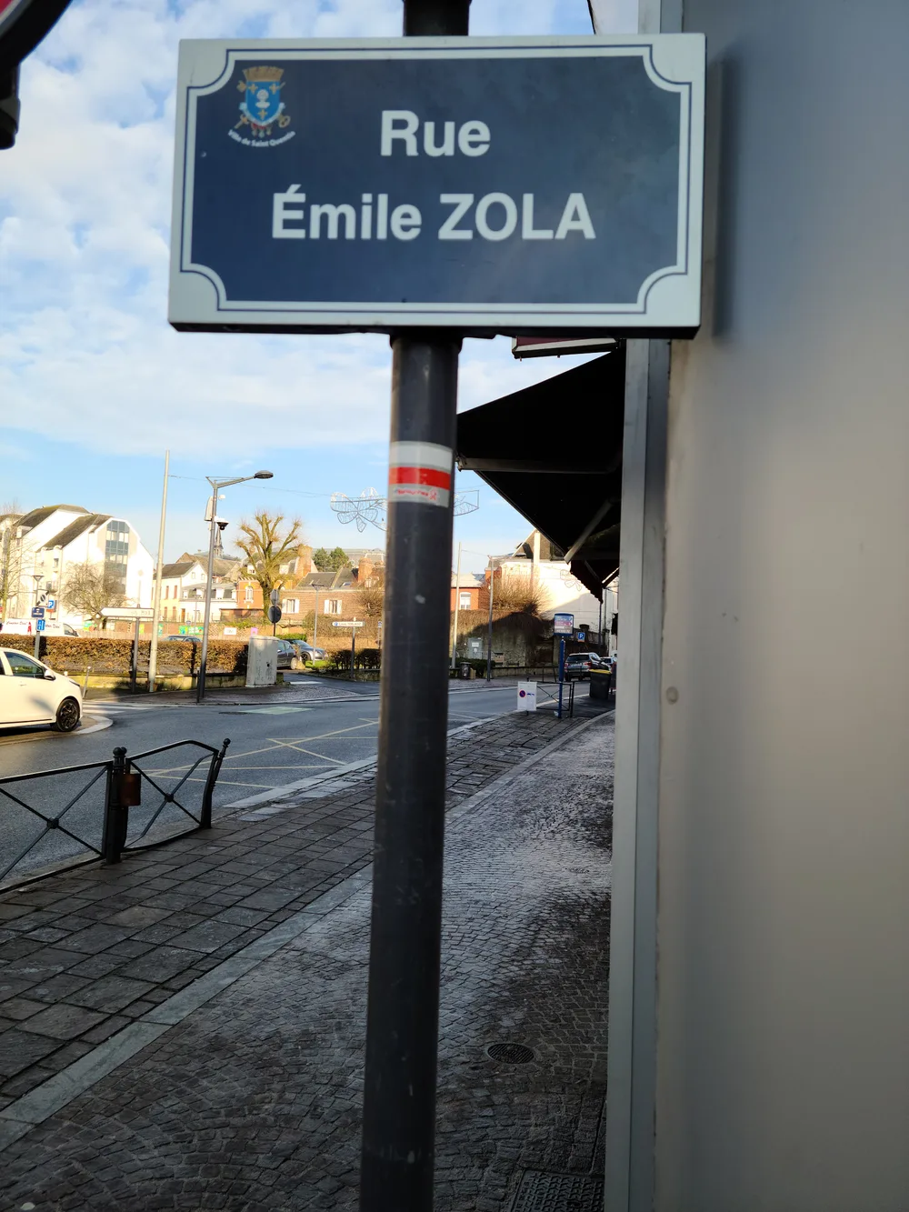 Rue Emile Zola street sign on a Saint-Quentin building near the tourist office